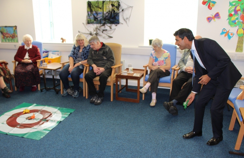 Rishi Sunak plays a game with attendees at the Bluebell House day centre