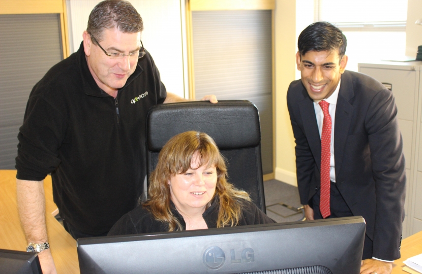 Rishi views OpenCRM's latest software with Graham Anderson, left